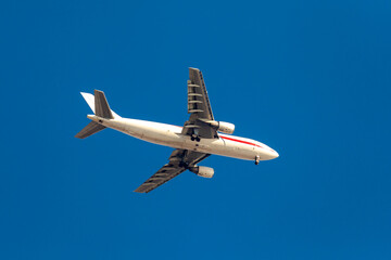 Large passenger plane flying in the blue sky