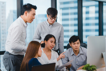 Collaborative process of multicultural businesspeople using computer presentation and communication meeting brainstorming ideas about project colleagues working plan success strategy in modern office.