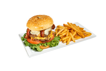 Double burger on white background with french fries, tomatoes, bacon, cheese, seeded hamburger buns and lettuce.  