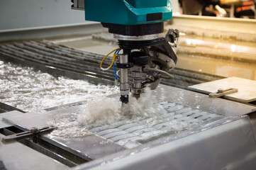 Modern CNC Abrasive water jet cutting machine using high pressure water jet to cut metal....