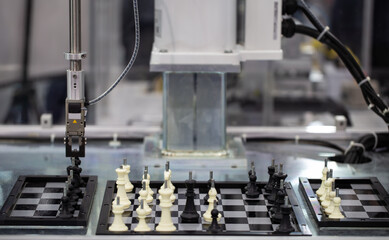 Industrial robot playing chess. Artificial Intelligence AI technology