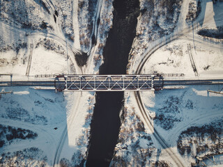 Winter railway bridge over the Siberian river