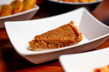 Gourmet Pumpkin Pie Dessert on White Plate Side View