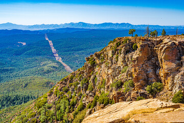 Looking over the edge of the Mogollon Rim to the forest below and the mountains beyond