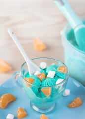 Fototapeta na wymiar blue ice cream with citrus pieces and marshmallows