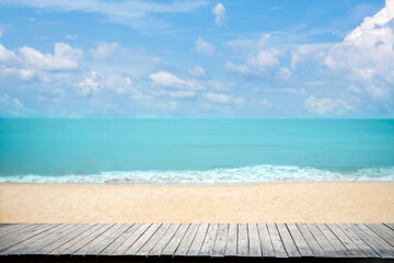 Close up wooden table top on sandy beach blue sea and tropical beach , Summer holiday concept.