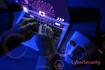 Professional hacker using laptop in dark room