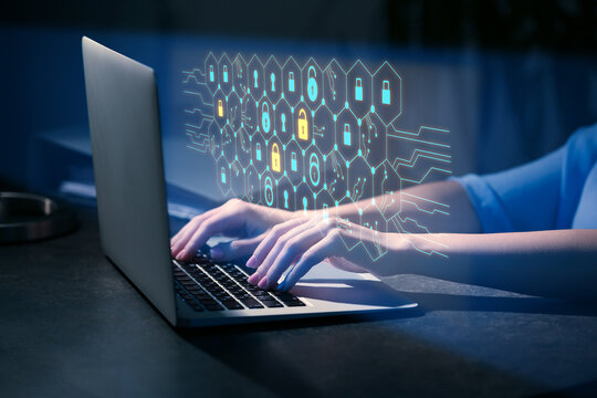 Woman with laptop using software for data protection on dark background