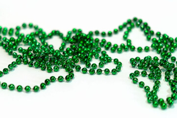 Decorative Christmas green beads for Christmas tree close-up on a white background. Beautiful green beads. Holiday decorations
