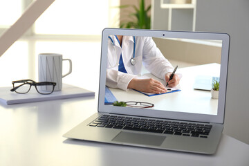 Male doctor during online meeting in clinic