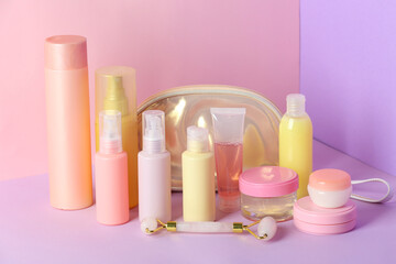 Travel cosmetics kit on color background