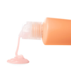 Pouring of travel bottle with cosmetic product on white background