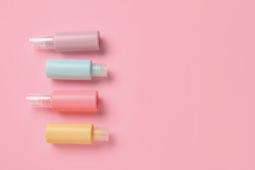 Set of travel bottles with body care cosmetics on color background