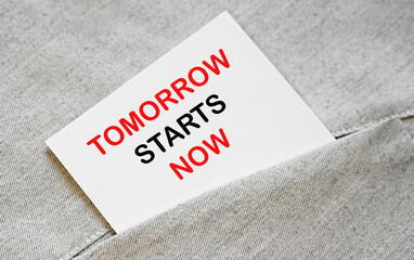 Tomorrow starts now. Motivational phrase on a note .