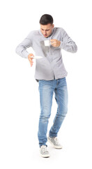 Stressed young man with coffee stains on his shirt on white background