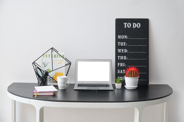 Modern workplace with laptop and todo list in office