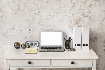 Comfortable workplace with modern laptop in room