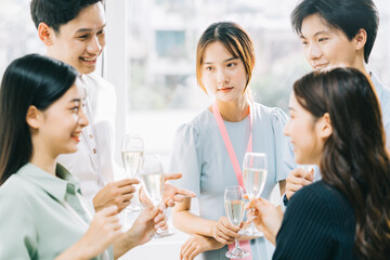 Group Asian business people are having a toast together and chatting at a company party