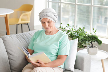 Mature woman after chemotherapy reading book at home