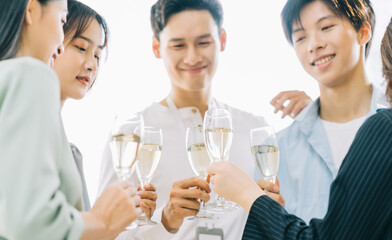 Asian bussiness people toast their glasses celebrating the results