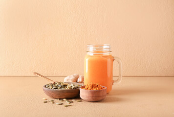 Mason jar of tasty pumpkin smoothie on color background
