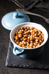 Mix of legume beans and chickpeas with sauce in pot.