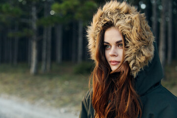 Pretty woman warm jacket on a background of trees Autumn forest lifestyle
