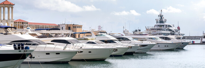 Fototapeta premium Speed boats at harbor. Power boats moored in marina. Sea coast pier.
