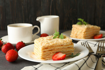 Concept of tasty lunch with Napoleon cake on gray wooden background