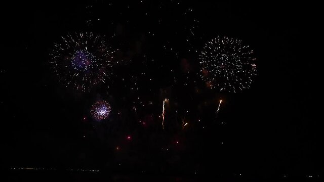 Elegant fireworks and fireworks display blurred on a black background