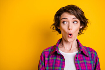 Obraz na płótnie Canvas Photo of surprised pretty young woman look empty space shopping sale isolated on yellow color background