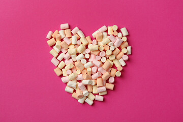 Heart made of marshmallow on pink background