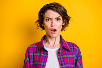 Portrait of irritated shocked young pretty woman negative bad news reaction isolated on yellow color background