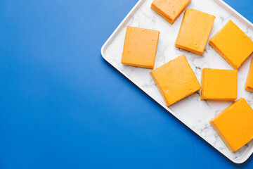 Plate with pieces of tasty pumpkin pie on color background