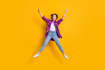 Fototapeta na wymiar Full size photo of happy cheerful young woman jump air star shape isolated on shine yellow color background
