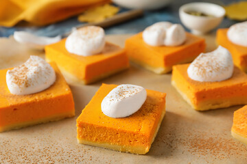 Pieces of tasty pumpkin pie on table