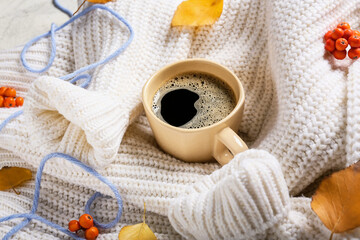 Beautiful autumn composition with clothes and cup of coffee