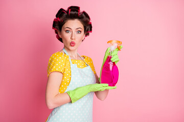 Portrait of astonished girl hold bottle sprayer wear yellow dotted t-shirt isolated over pastel...