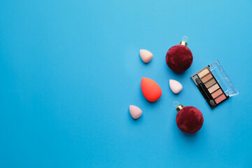 Christmas composition with cosmetics on color background