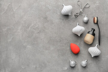 Christmas composition with cosmetics on grey background