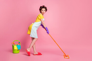 Full length profile side photo of cute maid girl wash floor mop wear dotted dress gloves isolated...