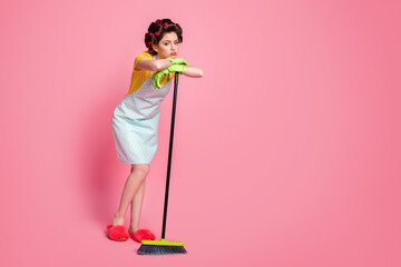 Full length body size view of nice glamorous tired lazy maid doing cleanup sweeping isolated on...