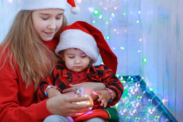 children in Christmas costumes with a Christmas tree toy. concept of new year, masquerade, holidays, decorations