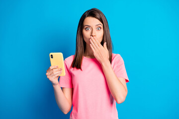 Portrait of charming horrified lady arm cover mouth no talk secret gossip isolated on blue color background