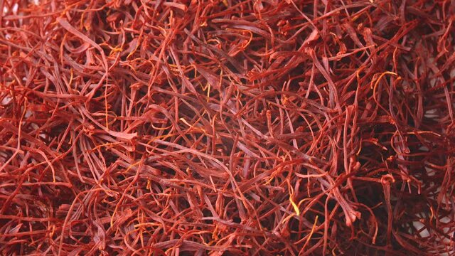 Saffron threads circling on white background