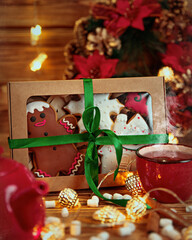 Photo of Christmas sweets with lights and a Christmas wreath as a gift.