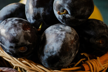 ripe blue plums in a basket