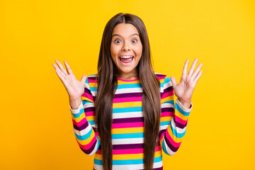 Photo of little girl open mouth raise palms crazy excited face wear striped shirt isolated yellow color background