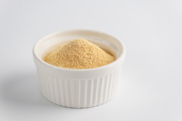 Sunflower lecithin in a bowl on a white background.