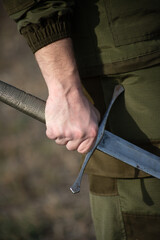 close-up photo of a hand with a sword